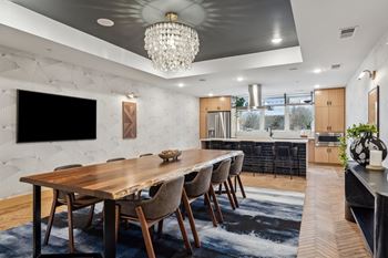 A modern dining room with a wooden table and chairs.